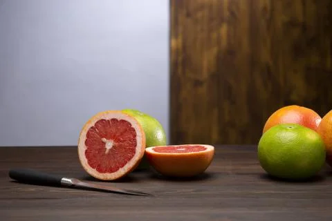 Sliced grapefruit with knife Stock Photos