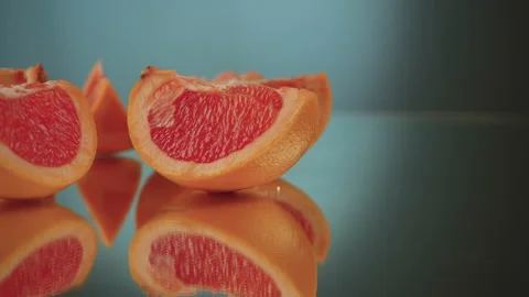 Sliced ​​grapefruit slices on a turntable. Close-up of grapefruit details. Stock Footage 171545534