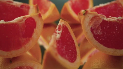 Sliced ​​grapefruit slices on a turntable. Close-up of grapefruit details. Stock Footage 171549232