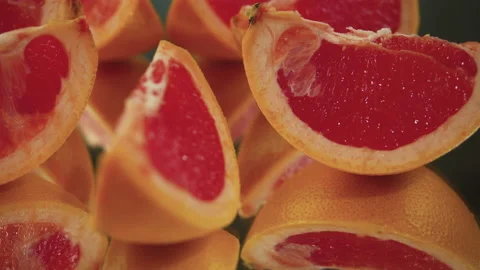 Sliced ​​grapefruit slices on a turntable. Close-up of grapefruit details. Stock Footage 171550096