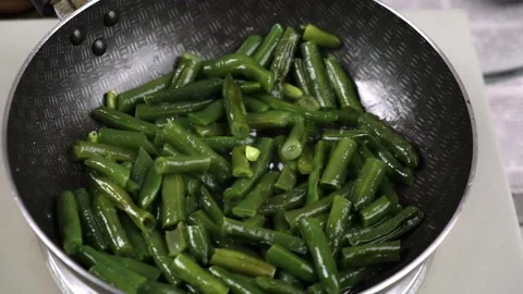 Sliced green string beans are stewed in a frying pan. close-up. slow motion. Stock Footage 190438223