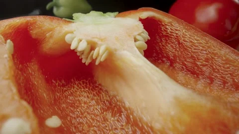 Sliced half of fresh raw red bell peppers on wooden board. Sweet pepper piece Stock Footage 203035905