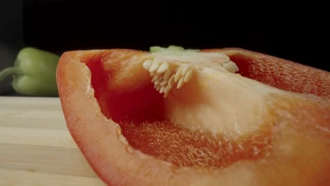 Sliced half of fresh raw red bell peppers on wooden board. Sweet pepper piece Stock Footage 203037711