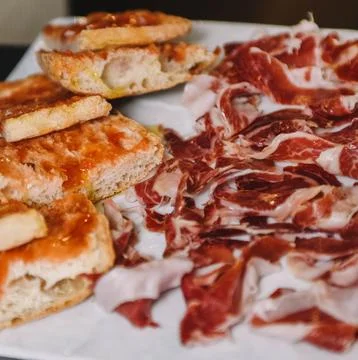 Sliced ​​ham and bread on a white plate Stock Photos