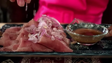 Sliced ham with onion topping on decorative plate beside dipping sauce and Video stock 343628368