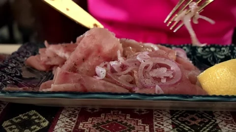 Sliced ham with onion topping on decorative plate beside dipping sauce and Video stock 343628924