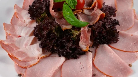 Sliced ham plate, pig meat, decorated with tomato and basil leaf Stock Footage 84262391