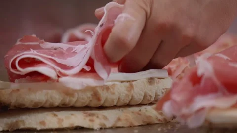 Sliced ​​ham prosciutto. Prosciutto is a raw, cured ham made from pork leg Video stock 297840400