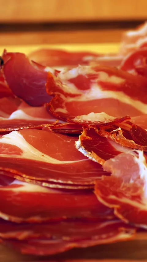 Sliced hamon, salami, bacon. meat. close-up. varieties of meat products. Stock Footage 317438076