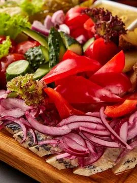 Sliced herring served with assorted vegetables. Stock Photos