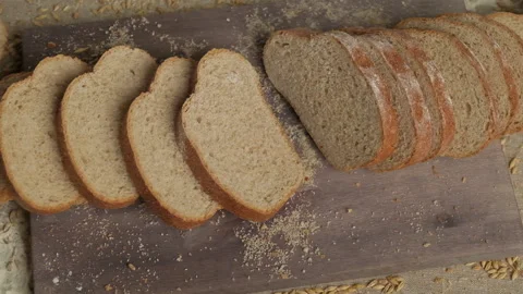 Sliced homemade bread falling at table. Top view of organic bread falling down Stock Footage 154684516