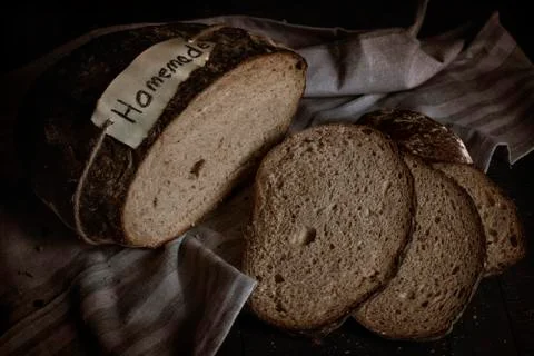 Sliced homemade rye bread. Kitchen table flat lay image Stock Photos
