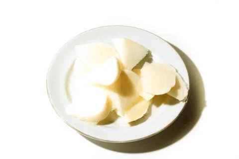 Sliced ??jicama on a white plate isolated on a white background Stock Photos