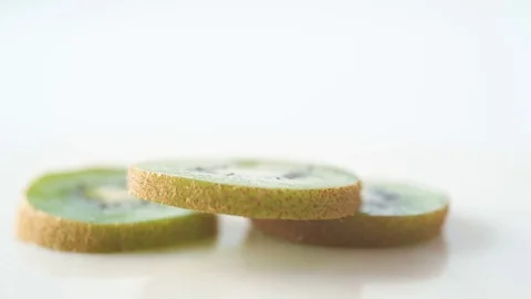 Sliced kiwi falling. Slow Motion. Stock Footage 79359285