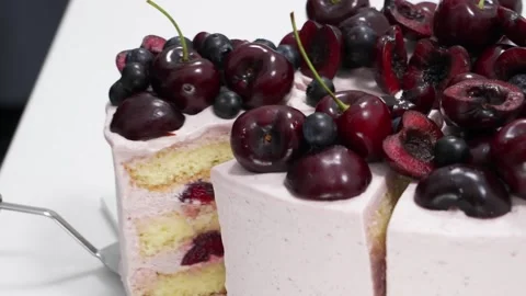 Sliced Layer Cake Topped with Fresh Cherries and Blueberries Stock Footage 343020926