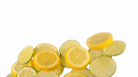 Sliced lemon and lime flying in slow motion on white background Stock Footage 118703071