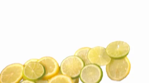 Sliced lemon and lime flying in slow motion on white background Stock Footage 118703074