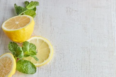 Sliced lemon and mint slices on a light wooden background. the view from the  Stock Photos