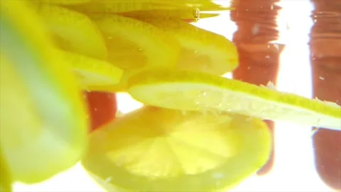 Sliced lemon and woman’s hand in the water Stock Footage 197473432