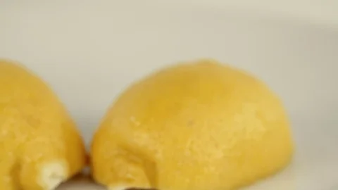 Sliced lemon falling on clean background Stock Footage 73350182