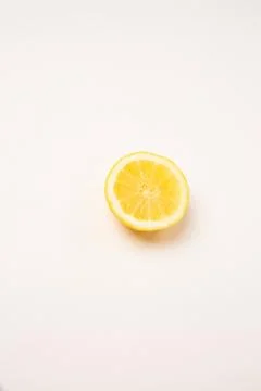 Sliced lemon on a light background. Copy space top and bottom. Stock Photos