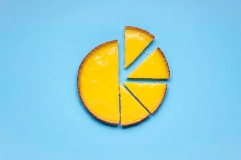 Sliced lemon pie on blue background. Fruit tart slices Stock Photos
