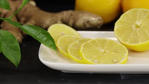 Sliced lemon slices lie in the foreground Stock Footage 123016484