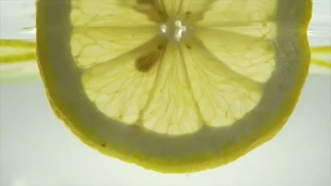Sliced lemon in the water Slow motion Stock Footage 197473434