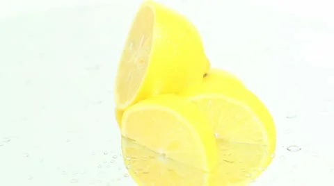 Sliced lemon on wet white surface Stock Footage 8992171