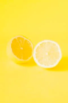Sliced lemon on yellow background Stock Photos