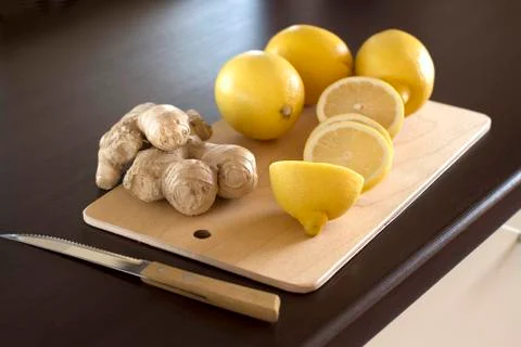 Sliced lemons and ginger root Stock Photos