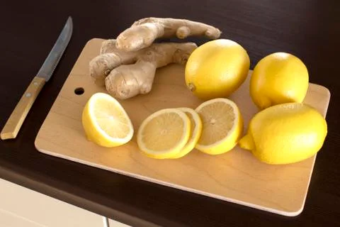 Sliced lemons and ginger root Stock Photos