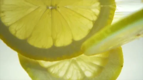 Sliced Lemons drop into the water　Slow motion Stock Footage 197473389