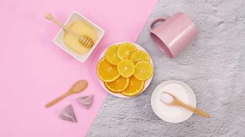 Sliced lemons move in circle and supplies for making tea move. Stop motion Stock Footage 147066463