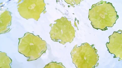 Sliced lime emerging out of water. Slow Motion. Stock Footage 87239316