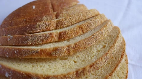 Sliced loaf of bread slowly rotating on white Video stock 47790173