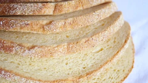 Sliced loaf of bread slowly rotating on white Video stock 47790421
