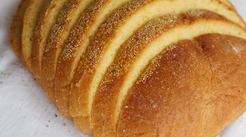Sliced loaf of bread slowly rotating on white Video stock 47790773