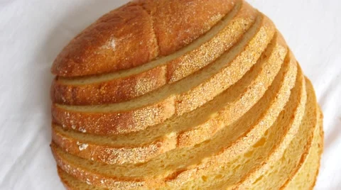Sliced loaf of bread slowly rotating on white Video stock 47791001