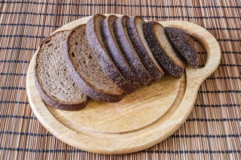 Sliced loaf of rye bread on a cutting board Stock Photos