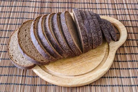 Sliced loaf of rye bread on a cutting board Stock Photos
