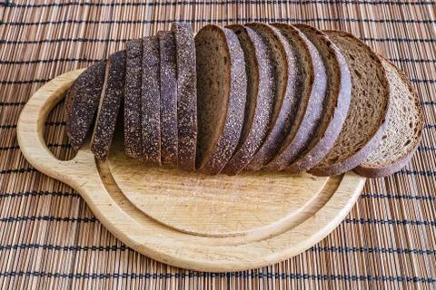 Sliced loaf of rye bread on a cutting board Stock Photos