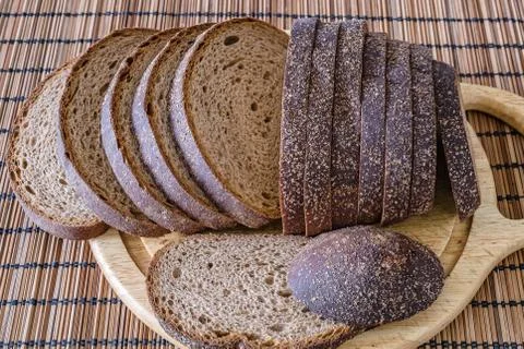 Sliced loaf of rye bread on a cutting board Stock Photos