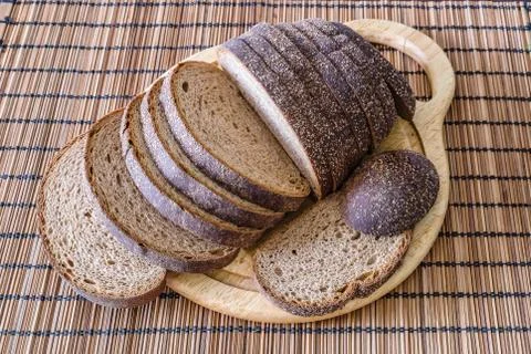Sliced loaf of rye bread on a cutting board Stock Photos