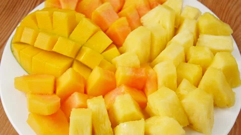 Sliced mango, pineapple, papaya on a plate. Stock Footage 239887756