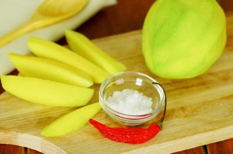 Sliced mango served with salt Stock Photos