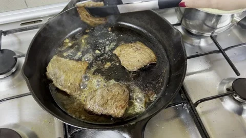 Sliced meat being flipped over using tongs Stock Footage 212082080