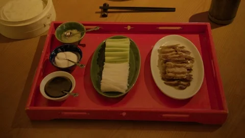 Sliced Meat, Vegetables, and Condiments Served on Tray in Beijing Restaurant Stock Footage 345773733