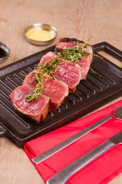 Sliced medium rare grilled Beef steak Ribeye with basil and cherry tomatoes Stock Photos