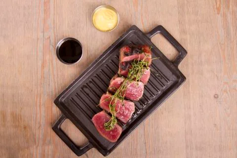 Sliced medium rare grilled Beef steak Ribeye with basil and cherry tomatoes Foto stock